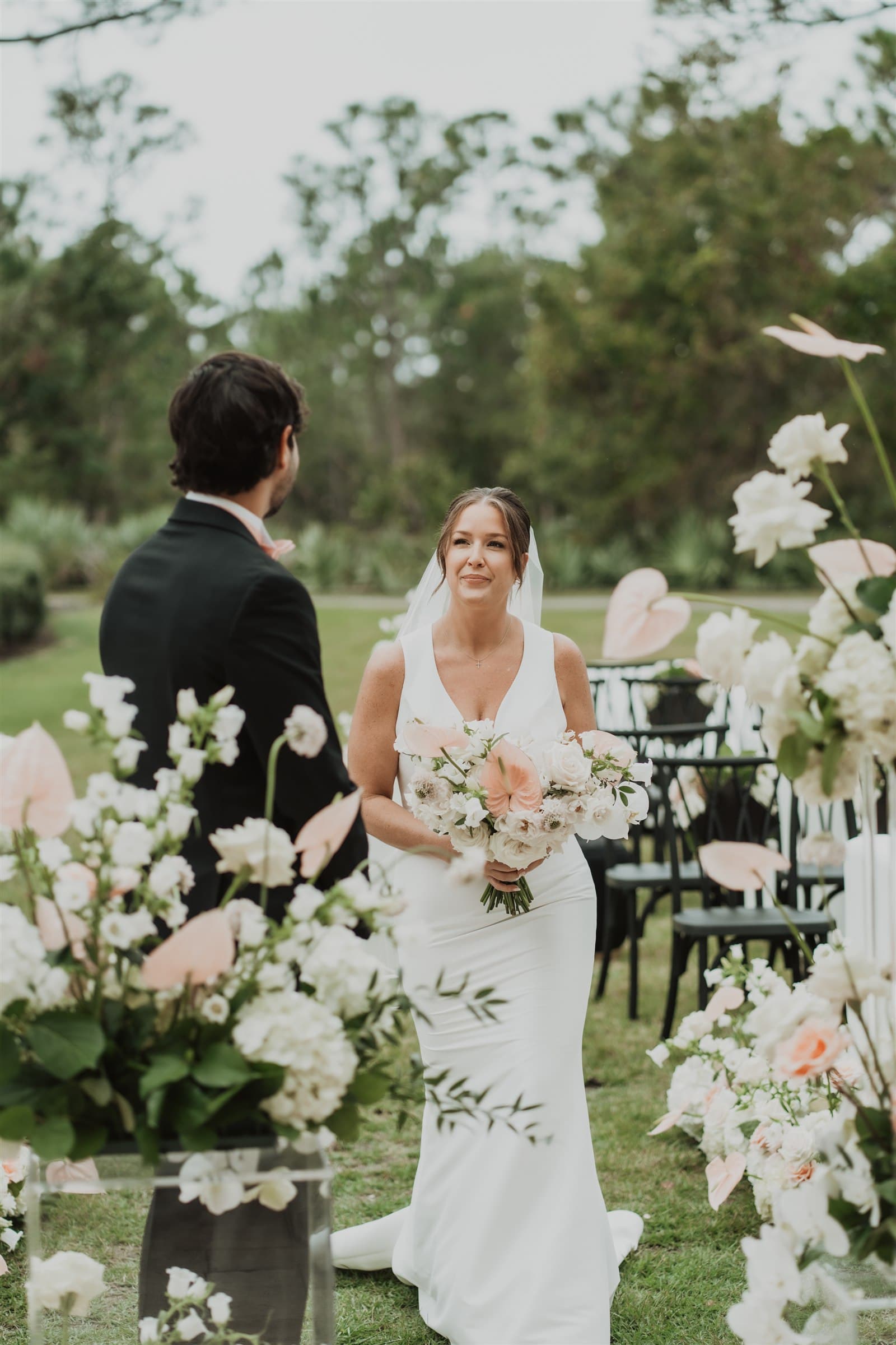 Bride walking down a flower-lined aisle
