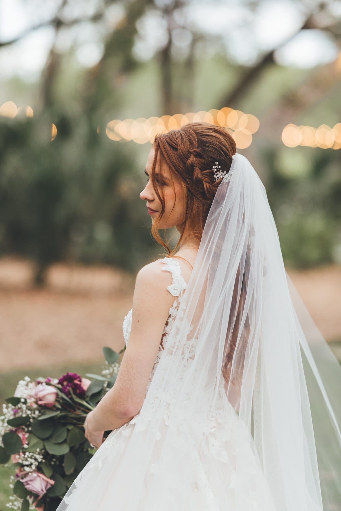 Detailed bridal hairstyling with a soft, luminous makeup look