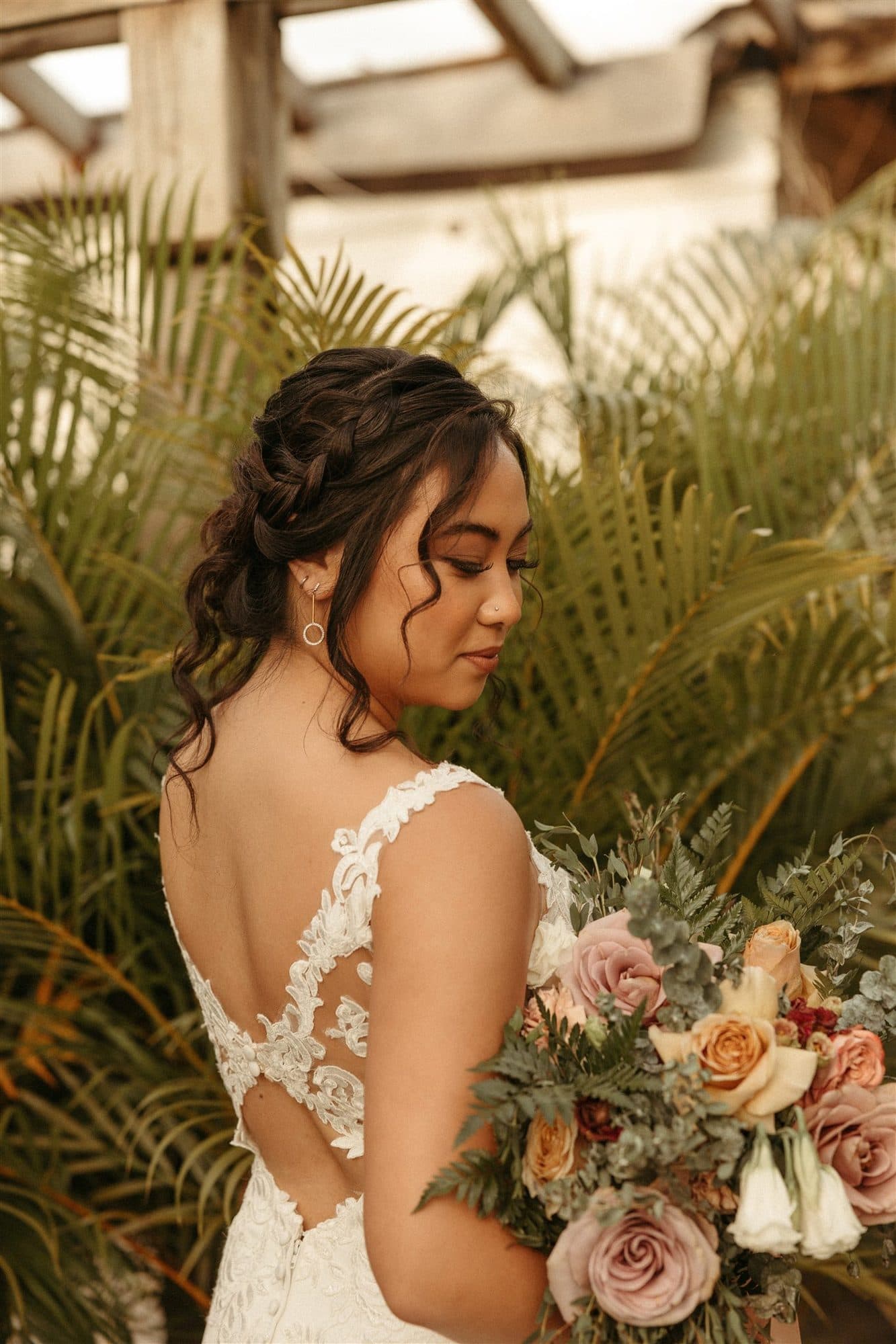 Detailed bridal hairstyling with a soft, luminous makeup look