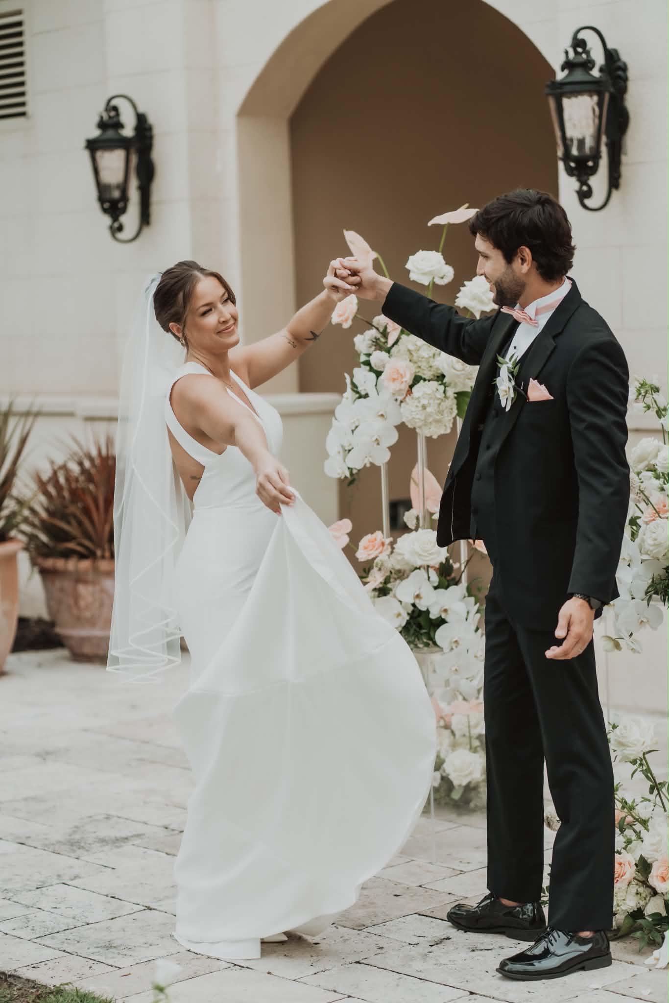 Bride and groom dancing together, her wedding-day hair and makeup holding through the celebration