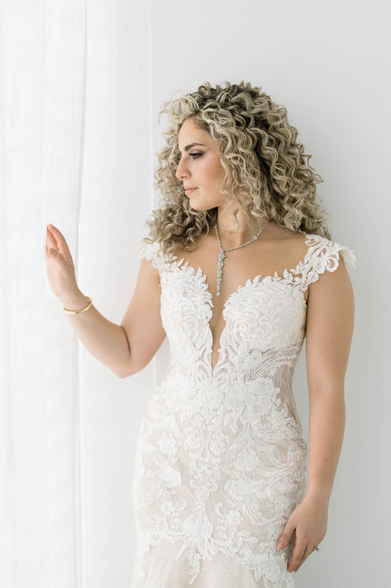 Bride embracing natural curls in a styled curly bridal look
