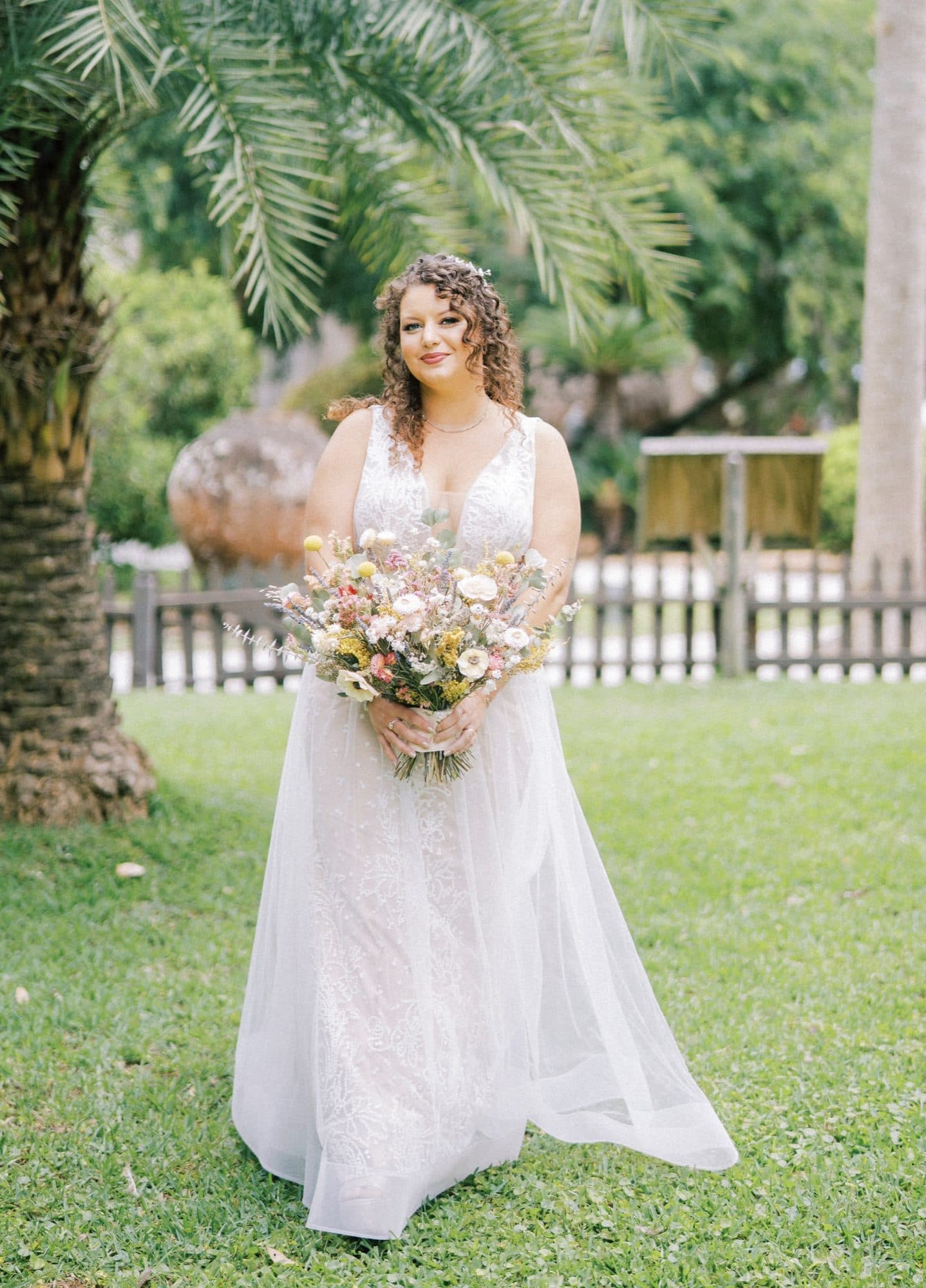 Curly blonde bridal hairstyle styled for the wedding day