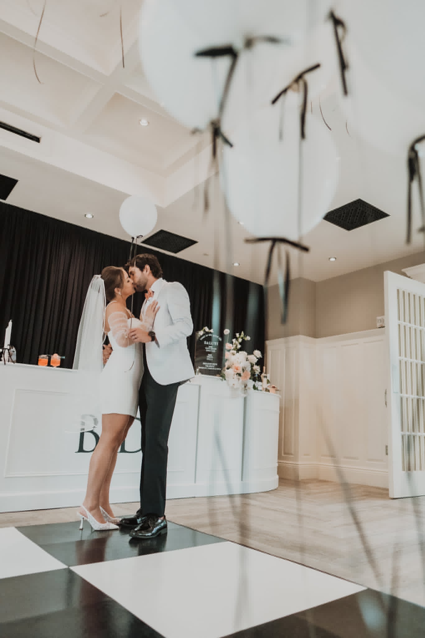 Bride and groom sharing a kiss on the dance floor at their reception
