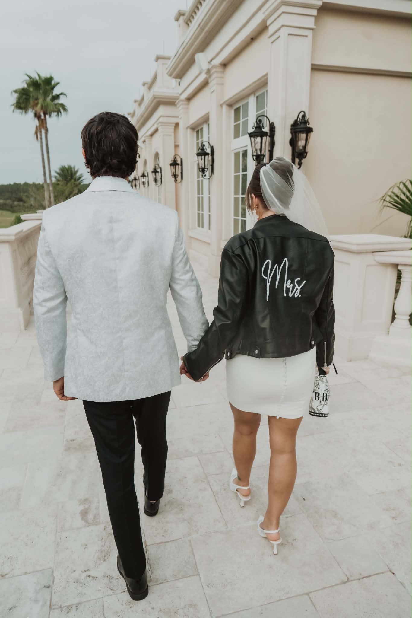 Bride and groom walking hand in hand after their wedding celebration
