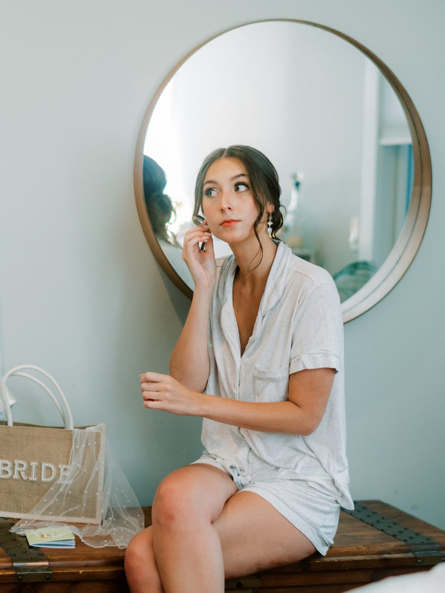 Bride getting ready on her wedding morning with hair and makeup underway