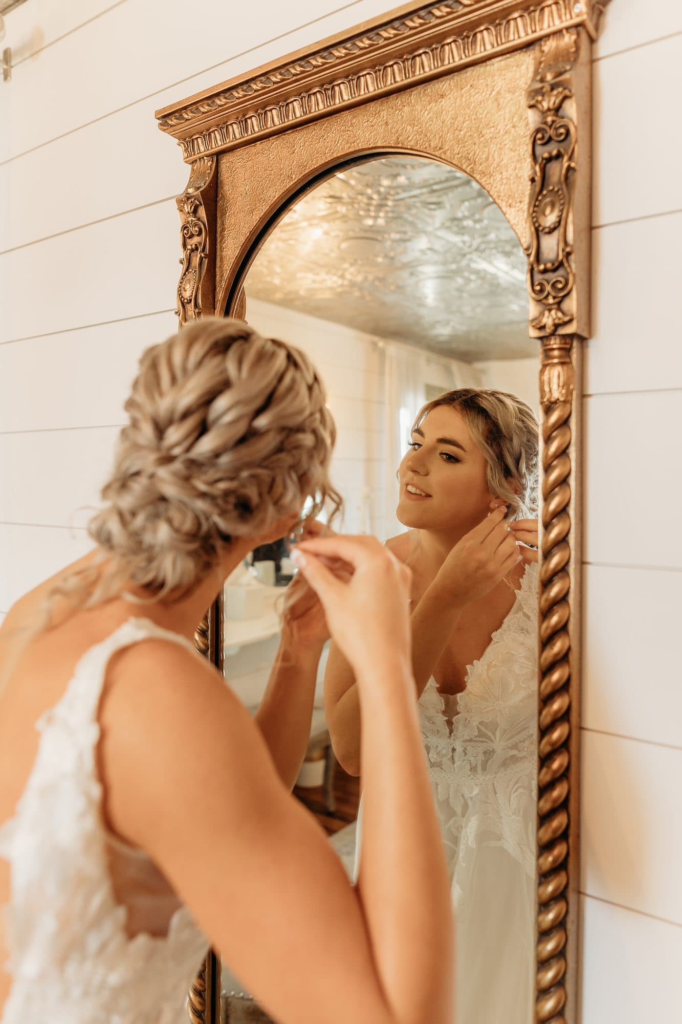 Bride getting ready on her wedding morning with hair and makeup underway